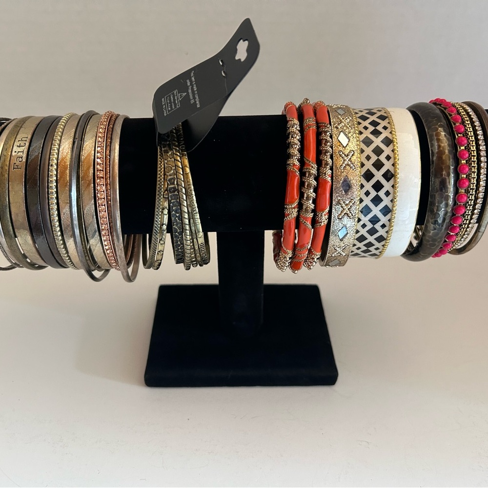 Lot of 32 vintage and modern gold and brass tone bracelets.